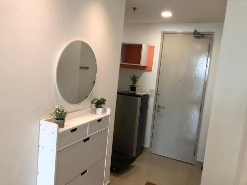 a bathroom with a sink and a mirror and a refrigerator at 4 Guest Studio Subang Jaya SS15 Courtyard First Subang LRT SS15 Subang Jaya Medical Center Subang Parade Nu Empire Subang Inti College Taylors College in Subang Jaya
