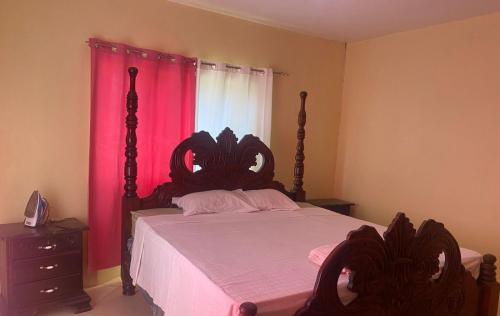 a bedroom with a large bed with a pink curtain at PINE VALLEY ESTATES 9b BALCONY VIEW TWO BEDROOM 2 BATHROOMS 