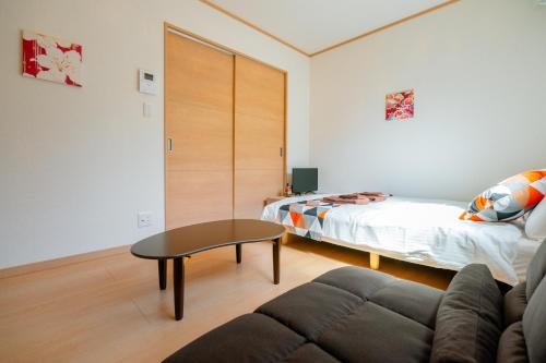 a living room with a couch and a bed at Ferio in Tokyo