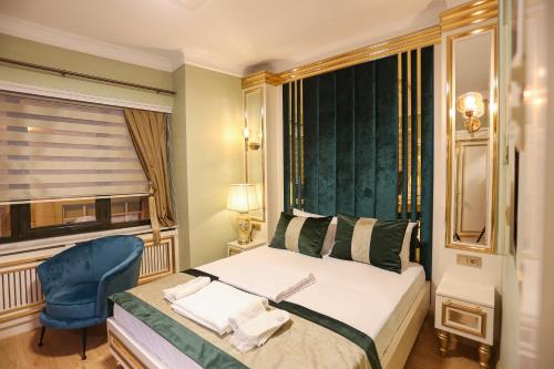 a bedroom with a bed and a chair and a window at WHITEMOON HOTEL SUİTES in Istanbul