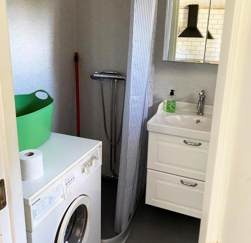 a bathroom with a washing machine and a sink at Nice and family friendly holiday home in Trensum Karlshamn in Trensum