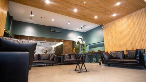 a waiting room with leather couches and a table at Green Sun Hotel in Manila