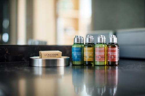 a group of four bottles of liquids sitting on a table at Hotel Nikko Kanazawa in Kanazawa