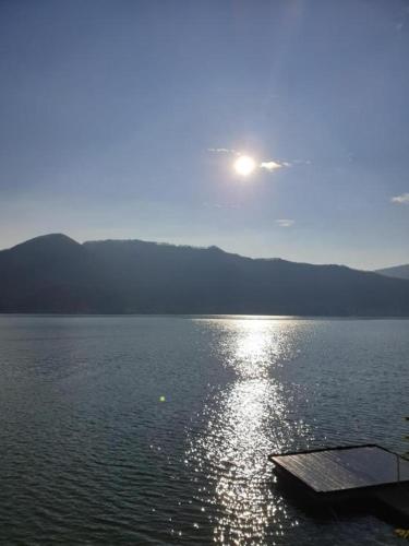 a large body of water with the sun in the sky at Bungalow- casute in Orşova