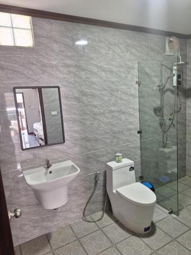 a bathroom with a toilet and a sink and a shower at Le KhounSok Boutique Hotel in Luang Prabang