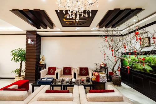 a living room with couches and a chandelier at Wild Lotus Hotel Apartment 2 in Hanoi