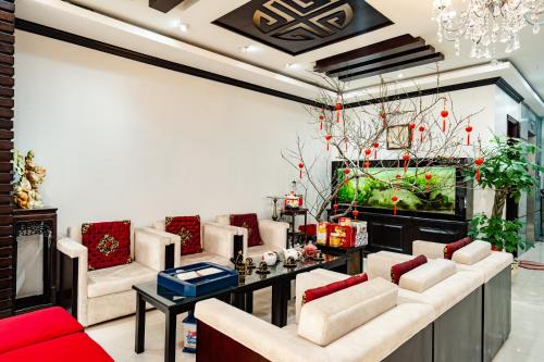 a living room with couches and a table at Wild Lotus Hotel Apartment 2 in Hanoi