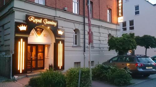 a car parked in front of a building with a sign at Hotel in in Amberg