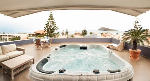 a hot tub on the roof of a house at Frideriki Studios & Apartments in Platanias