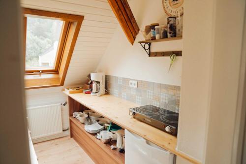 a small kitchen with a counter and a stove at Liebevoll Gästewohnungen in Alpirsbach