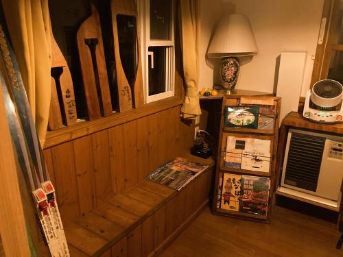 a room with a wooden paneled wall with a door at Urabandai Cranes in Kitashiobara