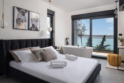 a bedroom with a large white bed and a bath tub at Soho in Punta