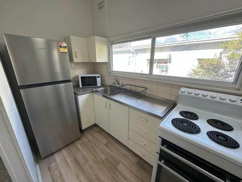 a kitchen with a stainless steel refrigerator and a stove at 1 Bedroom Apartment near Graftons Waterfront in Grafton