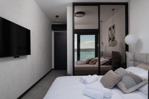 a bedroom with two beds and a flat screen tv at Soho in Punta