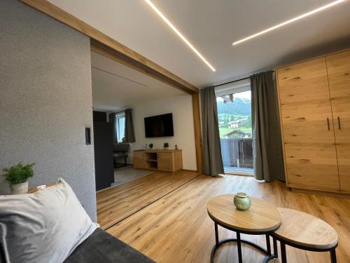 a living room with a couch and a table at Alpenglück - Hinterthal in Hinterthal