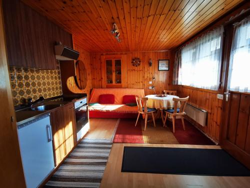 a kitchen and dining room with a table in a room at I de Mattu IDM1 in Blatten bei Naters