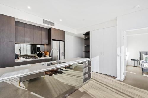 a kitchen with a stainless steel counter top at Luxury 2 Bedroom 2 Bathroom in the heart of South Brisbane in Brisbane
