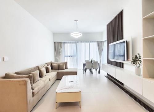 a living room with a couch and a tv at RH-Classy 1BR in Dubai Opera,near Burj Khalifa, full view from lobby in Dubai