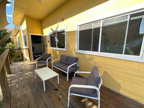 a patio with chairs and a table and windows at 2 Bedroom Apartment near Graftons Waterfront in Grafton