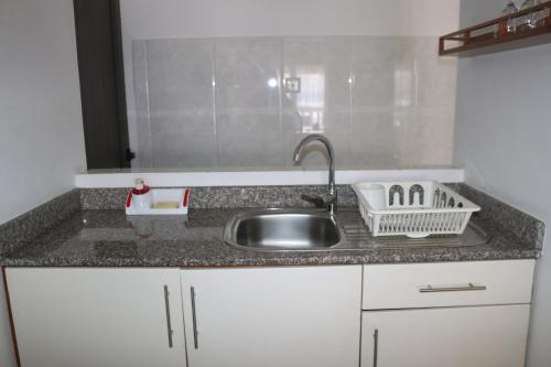 a kitchen with a sink and a counter top at Marie-France Beach Front Apartments in La Digue