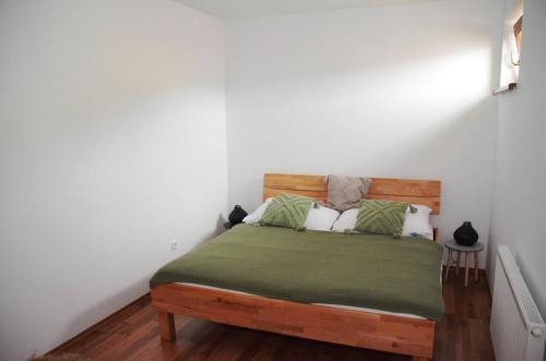 基約夫的住宿－Apartmán U Pepana，一间卧室配有一张带绿床单和枕头的床。