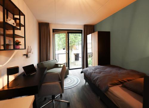 1 dormitorio con escritorio, 1 cama, escritorio y silla en Wittenborg Student Studios, en Apeldoorn