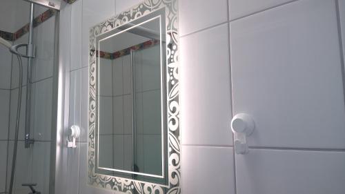 a bathroom with a mirror on the wall at Rob´s Place in Langenfeld