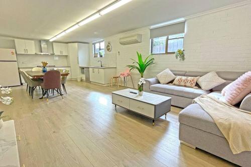 a living room with a couch and a table at Pet Friendly Well-appointed 3BM Retreat Parking Netflix in Ringwood