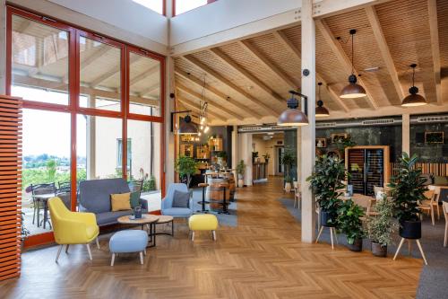 a lobby of a store with chairs and tables at JUFA Hotel Deutschlandsberg in Deutschlandsberg