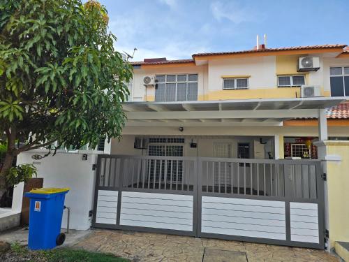 a house with a white gate and a fence at Sapphire Residence in Jenjarum