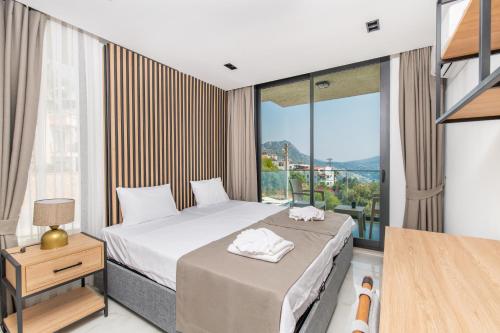 a bedroom with a bed and a large window at Eco Villa ECE in Kalkan