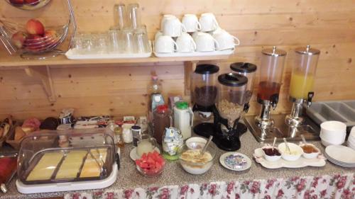 a kitchen counter with a bunch of food and a counter at Kék Lagúna Wellness Apartmanok in Egerszalók