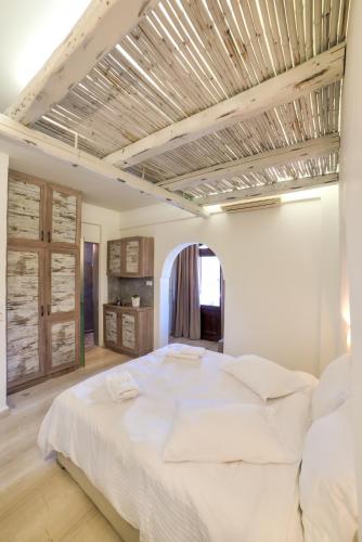 a bedroom with a large white bed in a room at Ifestos Villa in Fira