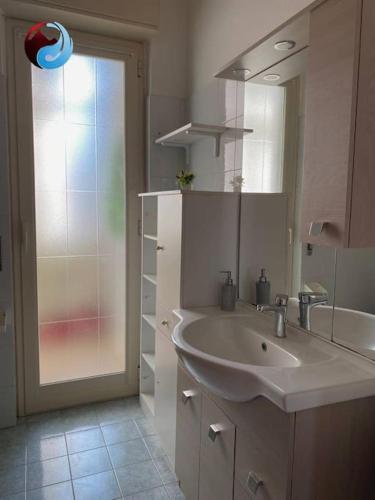 a bathroom with a sink and a mirror and a shower at La Dolce Vista, Mitogio(Ct) in Gaggi