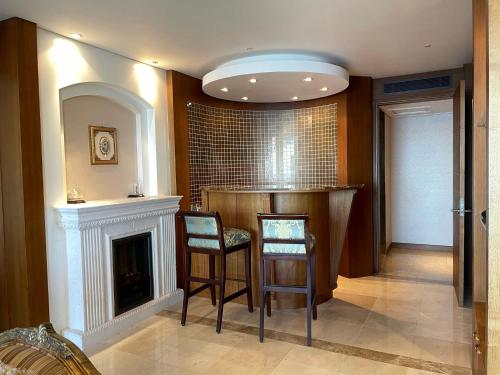 a living room with two chairs and a fireplace at Hotel Maremons in Sokcho