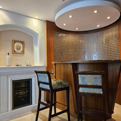 a bar with a chair and a fireplace at Hotel Maremons in Sokcho
