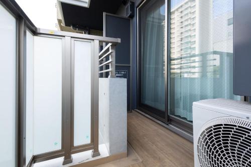 a room with large windows and a staircase at Lafesta Higashikomagata in Tokyo