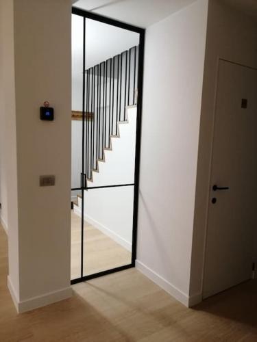 a hallway with a mirror and a stair case at Akkerland - Luxe vakantiehuisje met Infra-Rood sauna - 2 à 6 pers in Zonnebeke