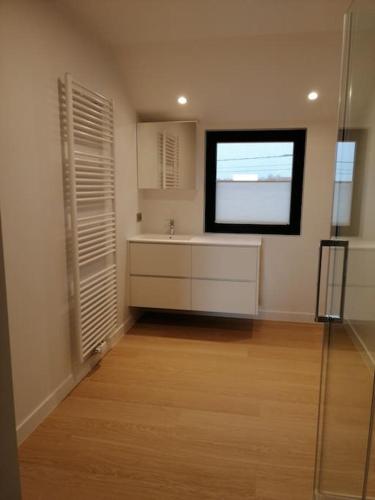 a kitchen with a sink and a window in a room at Akkerland - Luxe vakantiehuisje met Infra-Rood sauna - 2 à 6 pers in Zonnebeke