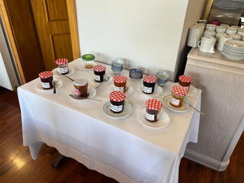 a table with cups and plates of desserts on it at Hôtel du Rangen in Thann