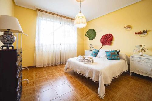 a bedroom with a bed and a window at La Huertina De Granda in Candanal