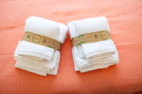 two towels sitting on top of a bed at La Huertina De Granda in Candanal