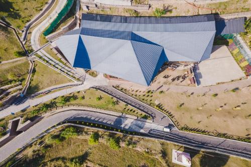 an overhead view of a building with a blue and white structure at Skyview by Empyrean in Patnitop