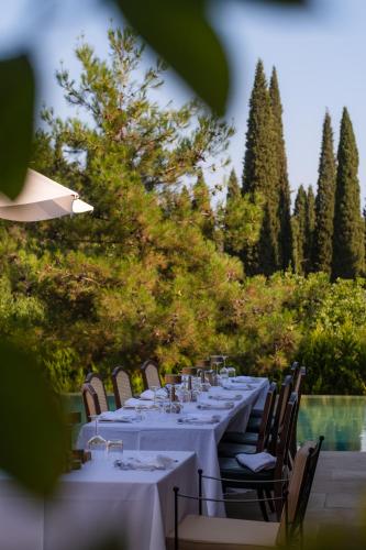 a long table with white tables and chairs at Nadas Kazdağları in Canakkale