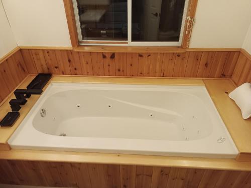 a jacuzzi tub in a room with a window at Fireside - Waterfront Resort Style Executive Cottage in Kawartha Lakes