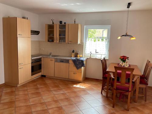 a kitchen with a table and a dining room at Wellenwiese 29 in Zingst