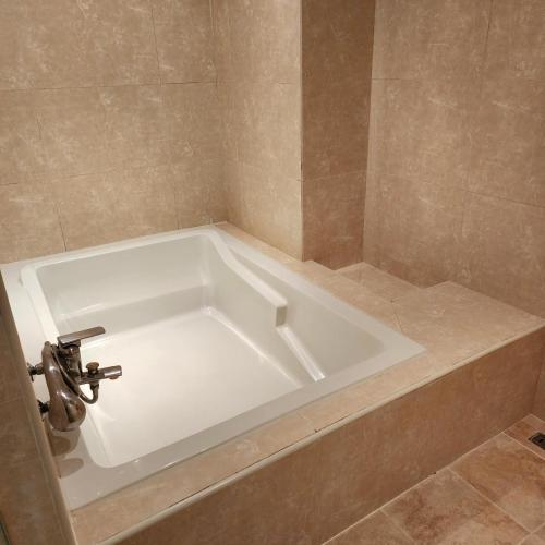 a white bath tub in a bathroom at Hotel Maremons in Sokcho