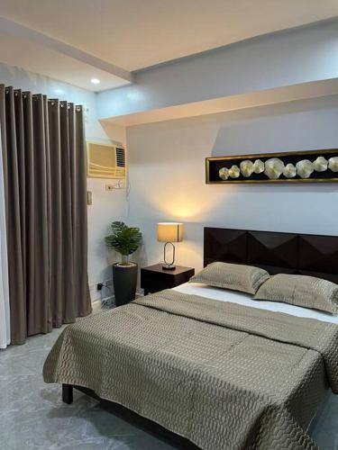 a bedroom with a large bed in a room at My Suite Heart of San Juan City Near Ortigas in Manila