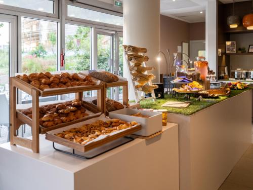 a bakery with various types of breads and pastries at Novotel Nantes Centre Gare in Nantes