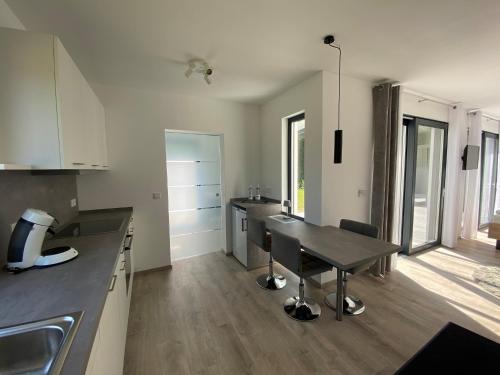 a kitchen with a table and a dining room at Ferienhaus Residenz am Stausee in Schotten